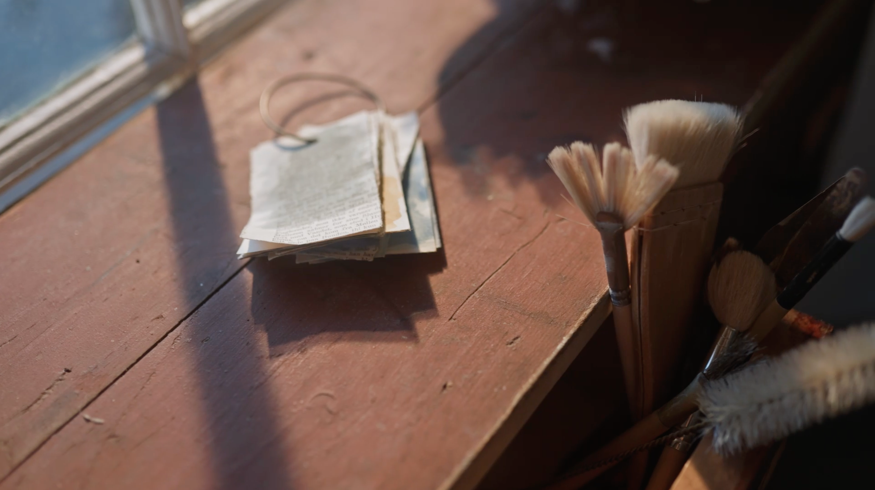 Tools for creating ceramics along with paper tags on a wooden table