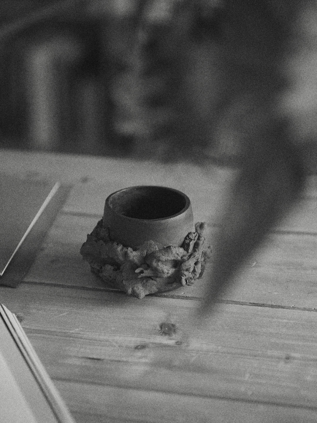 Ceramic cup on a textured surface with a blurred background